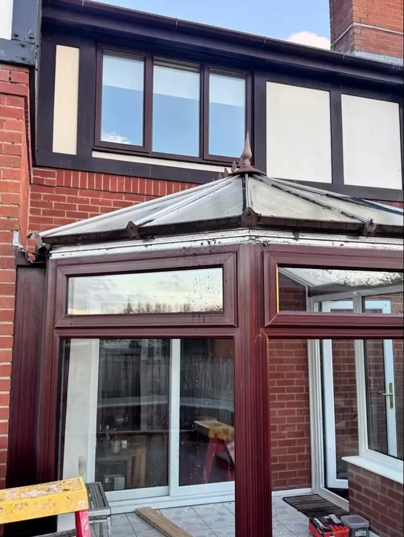 The conservatory before, with its old polycarbonate roof