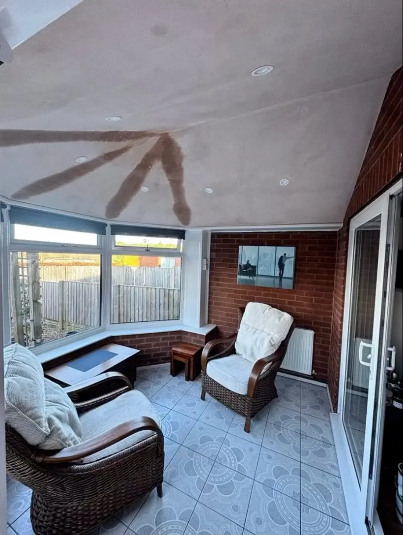 Inside a conservatory after its new solid roof, with plastered ceiling and spotlights