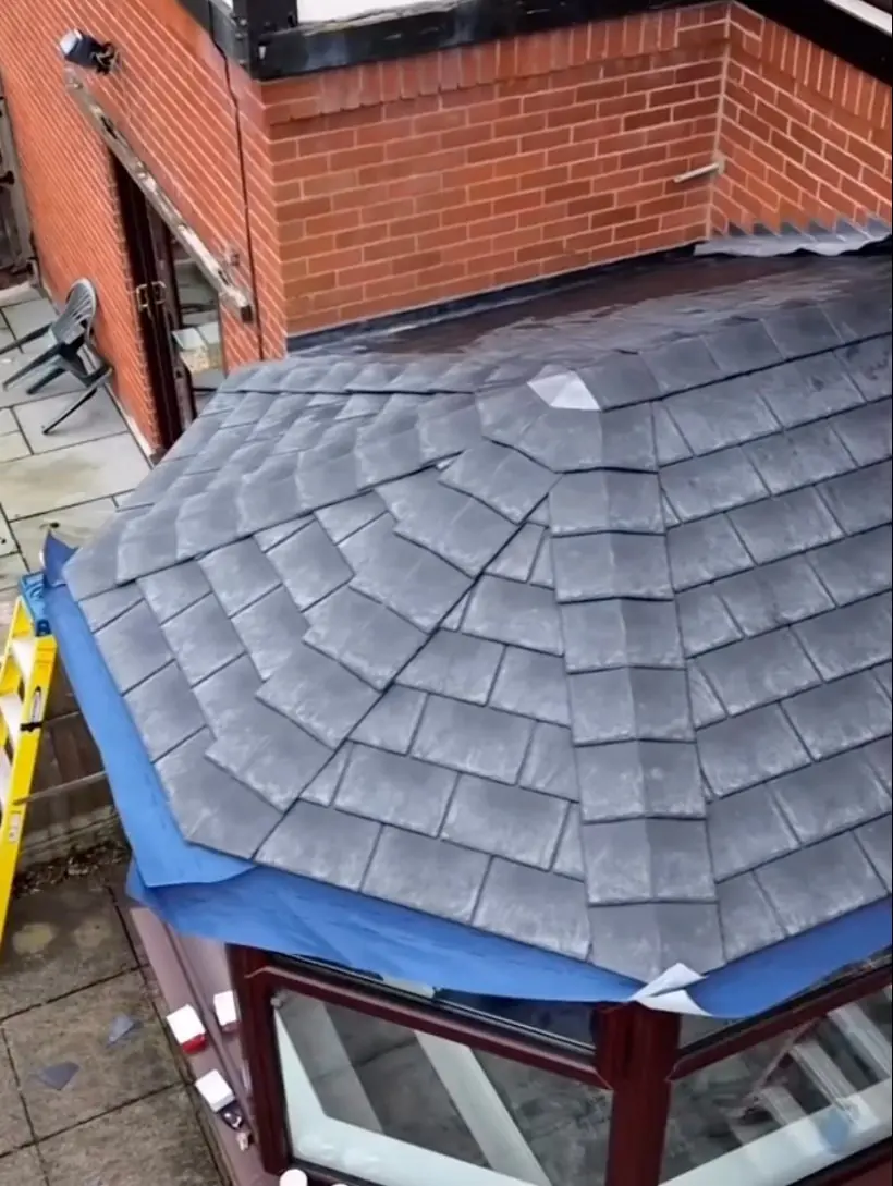 The new lightweight tiled roof on the conservatory
