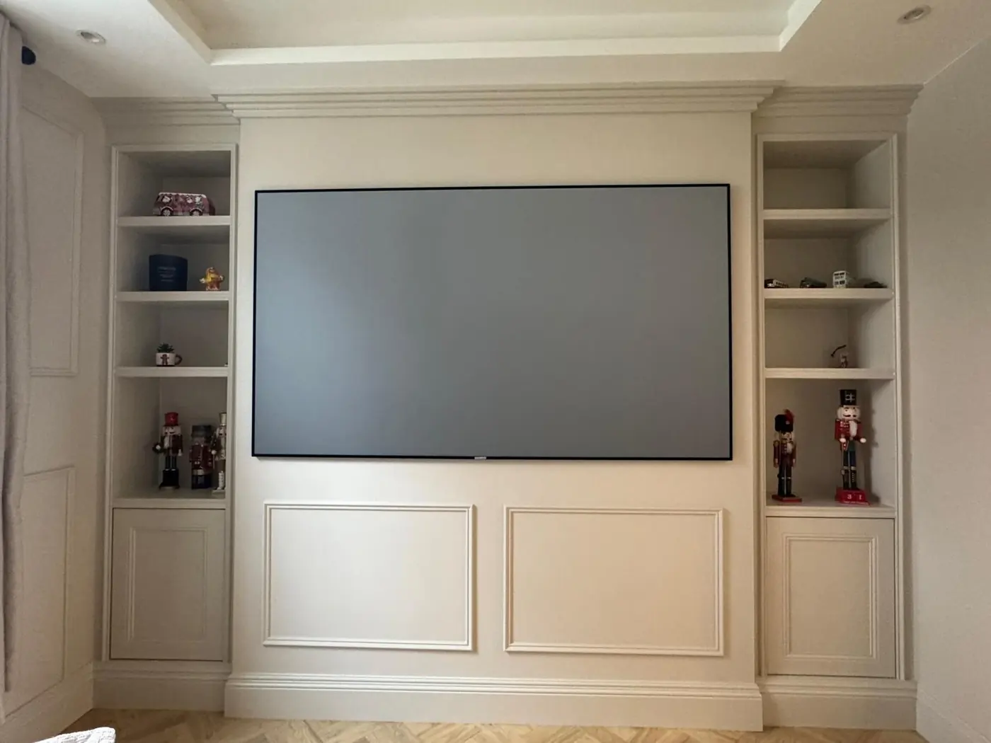 Panelled media wall with shelving towers
