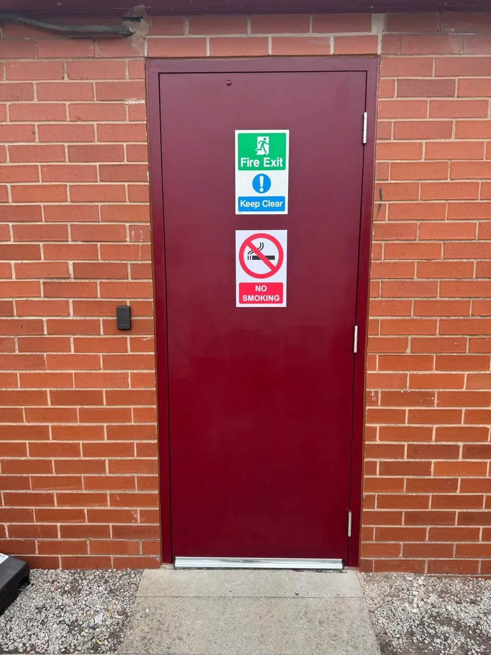 External fire exit door with threshold, signage and access reader