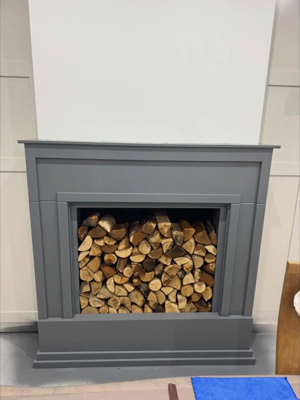 Painted fireplace surround with log store