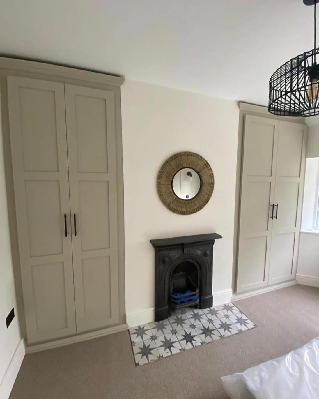 Shaker-style fitted units either side of a bedroom fireplace