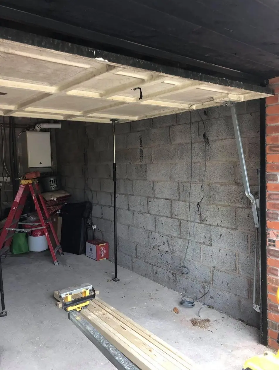 The garage before the conversion: bare block walls and an up-and-over door