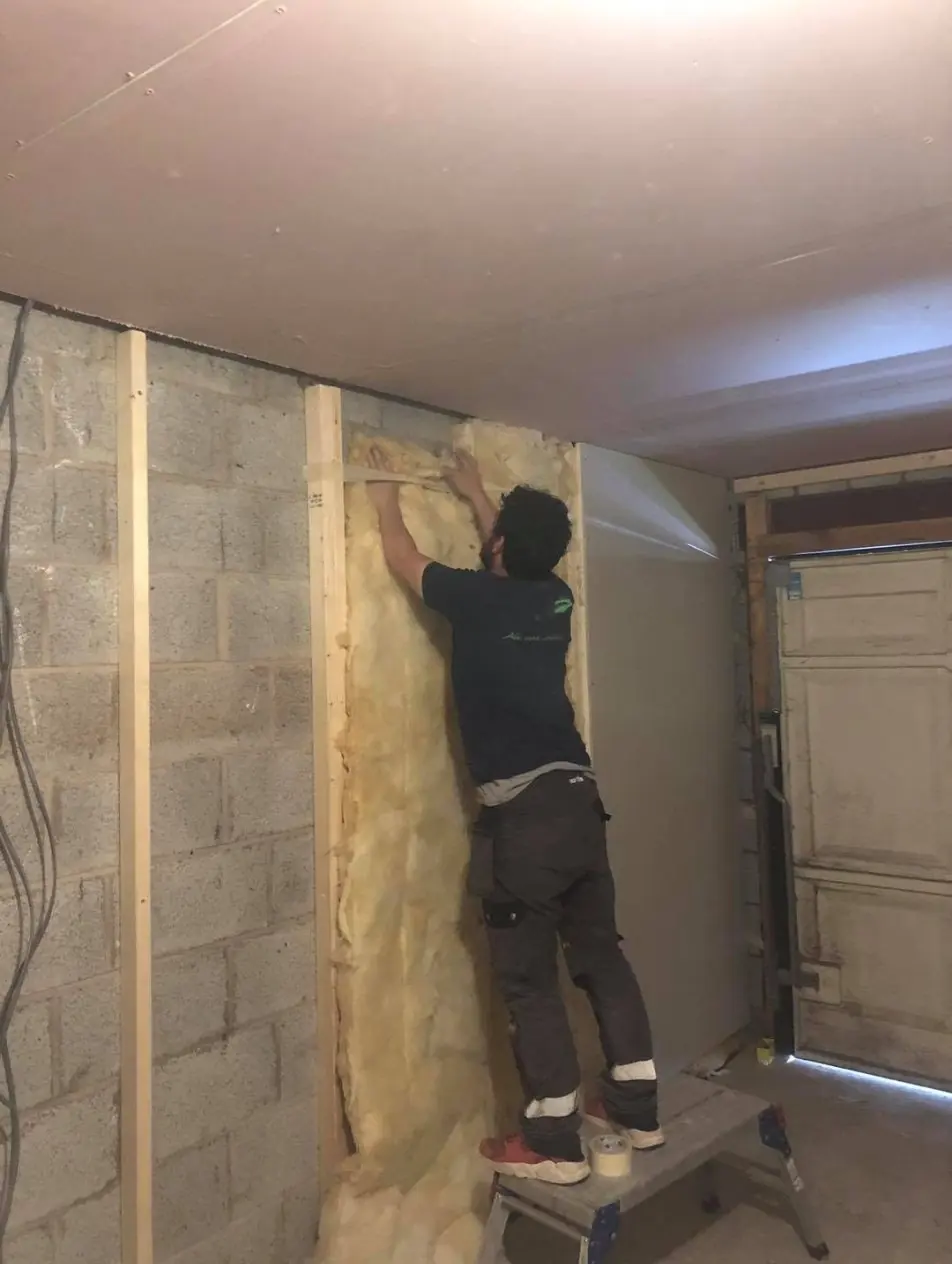 Ash insulating the stud walls during the garage conversion