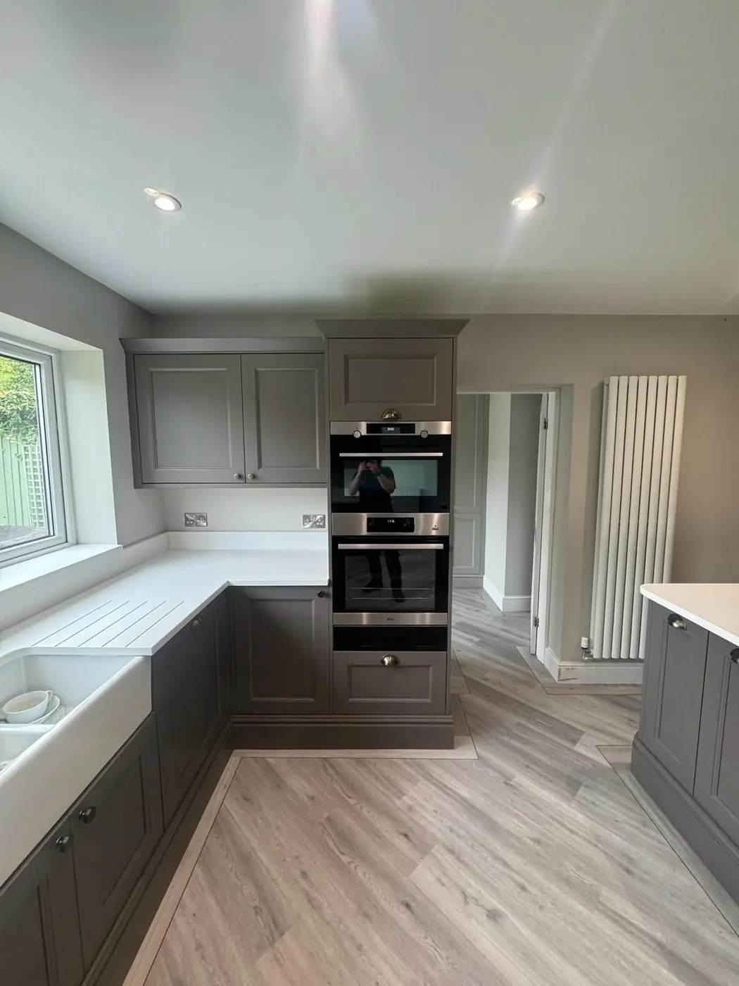 Grey shaker kitchen with tower ovens