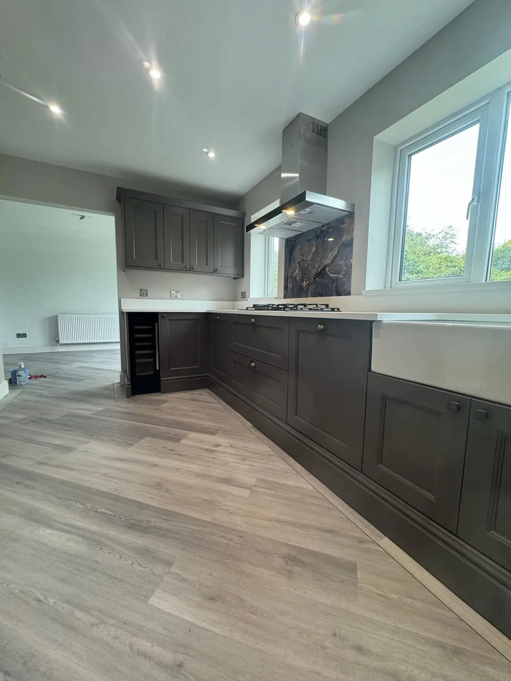 Grey shaker kitchen run with Belfast sink