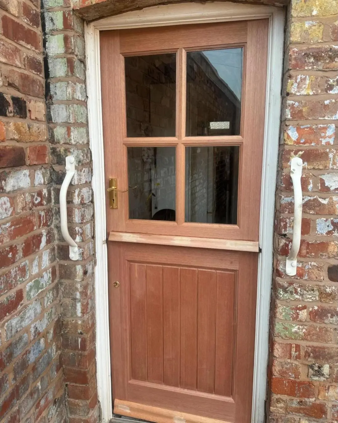 Hardwood stable door fitted to a brick house