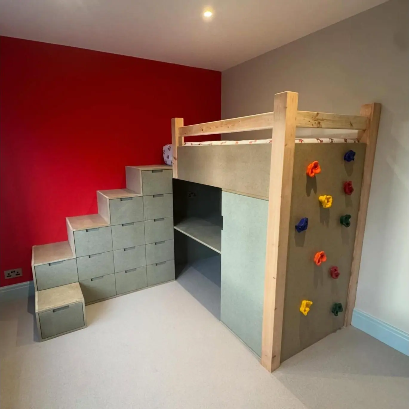 Children's bed with climbing wall, storage stairs and wardrobe