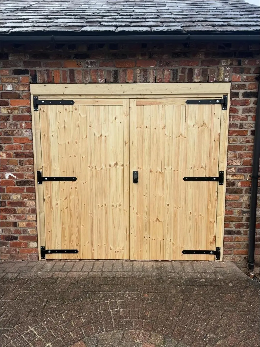 Timber garage doors with black hinges